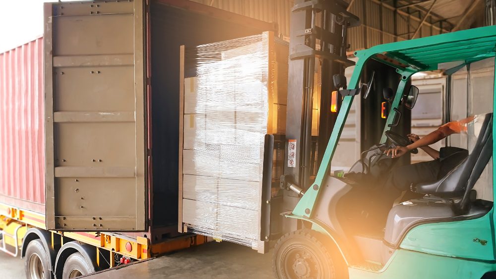 Forklift loading wrapped stock into a delivery truck