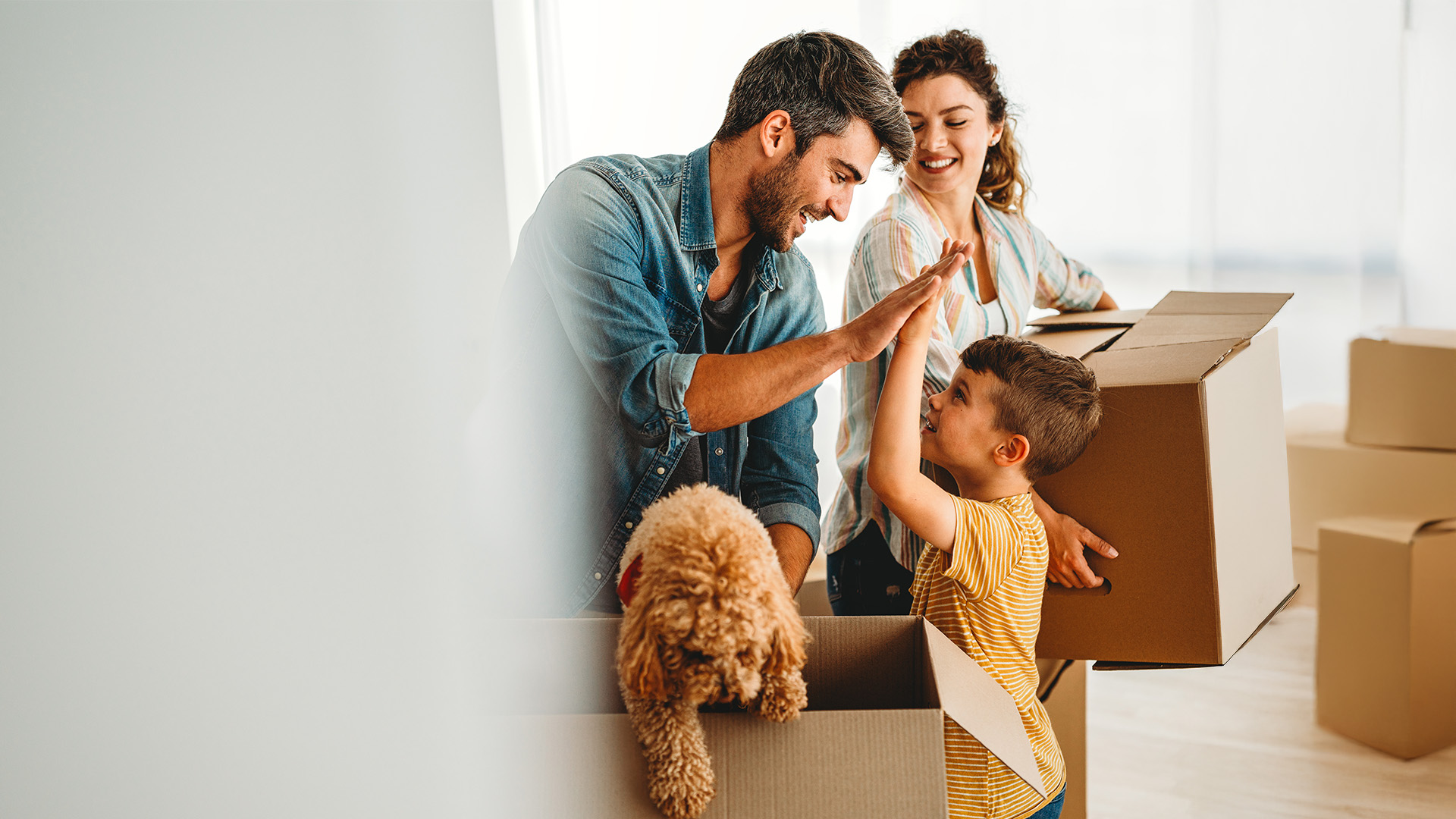 Family celebrating moving day with boxes