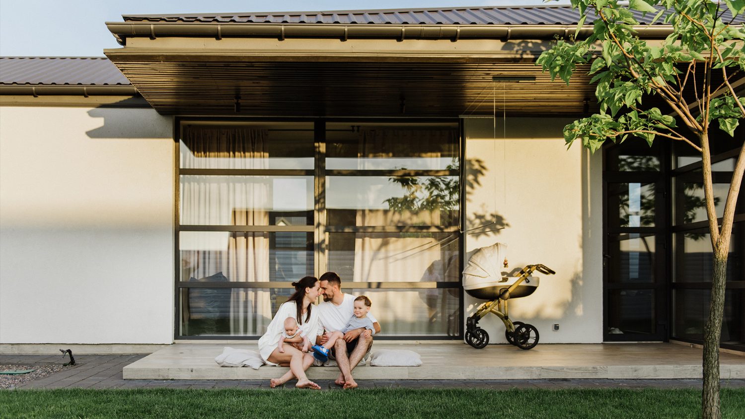 Family relaxing outside their new home