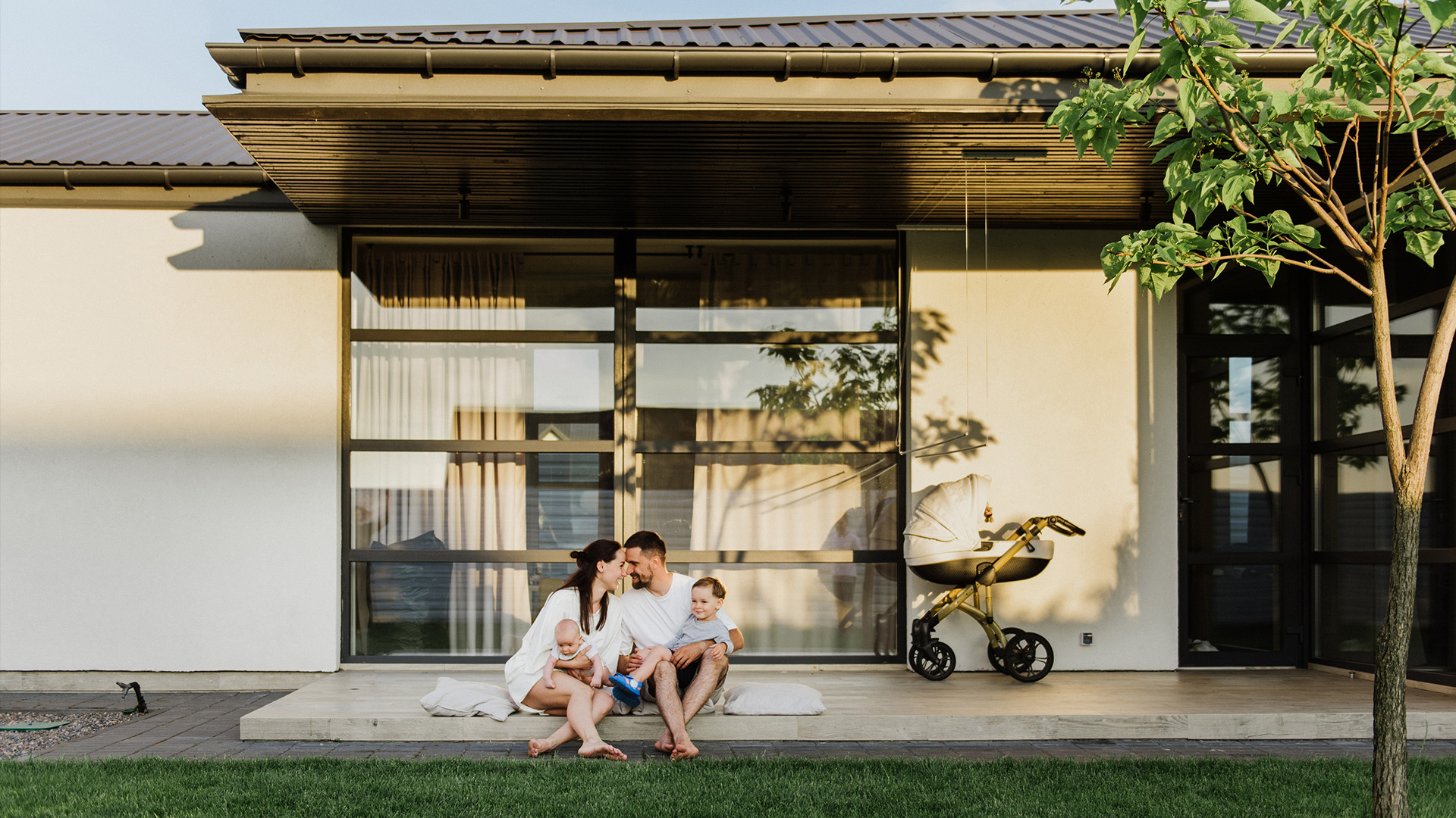 Family relaxing outside their new home